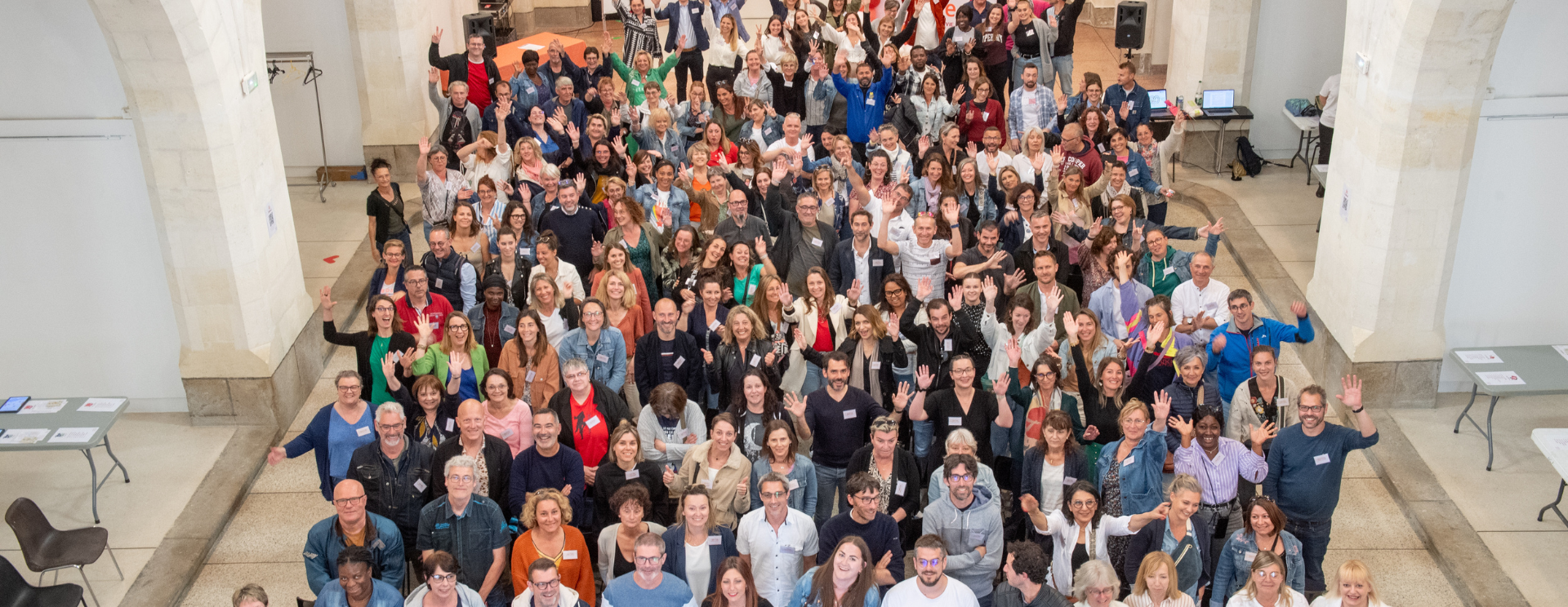 Photo des collaborateurs de Silène prise lors de la journée du personnel en juin 2024 dans la galerie des franciscains. Photo prise de haut, les collaborateurs ont le sourire et lève les bras pour certains.